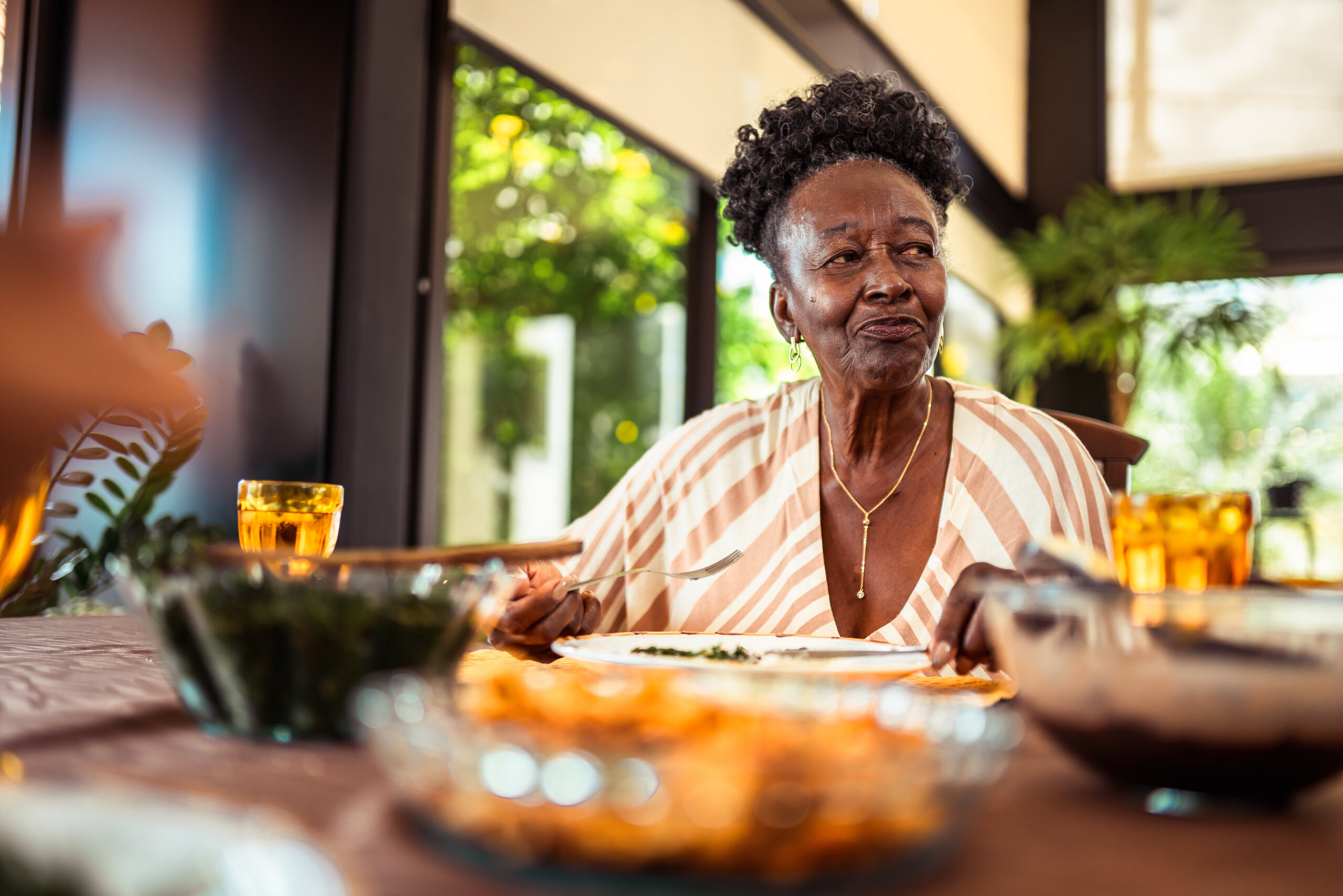 Woman enjoying a nourishing meal, part of restoring the body before pursuing further fat loss